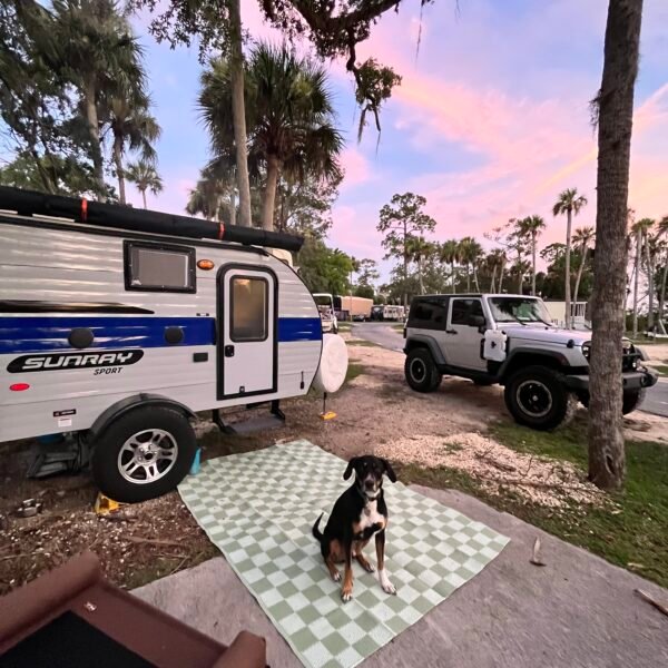 Sunray 109 Sport Travel Trailer in front of a cotton candy colored sky