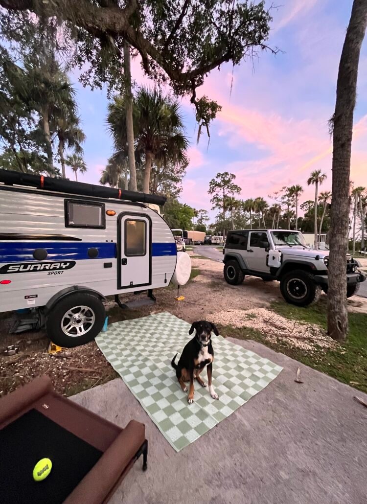 Sunray 109 Sport Travel Trailer in front of a cotton candy colored sky