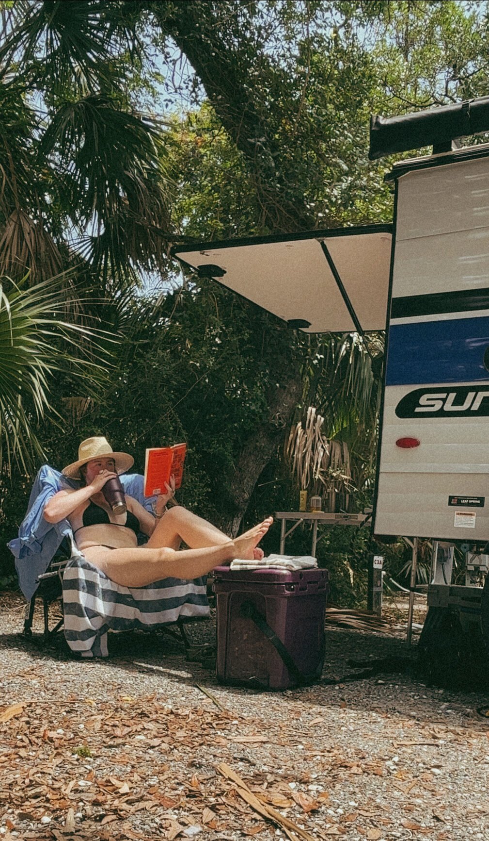 Kasey wearing a wide brim hat at camp by her Sunray 109 Sport